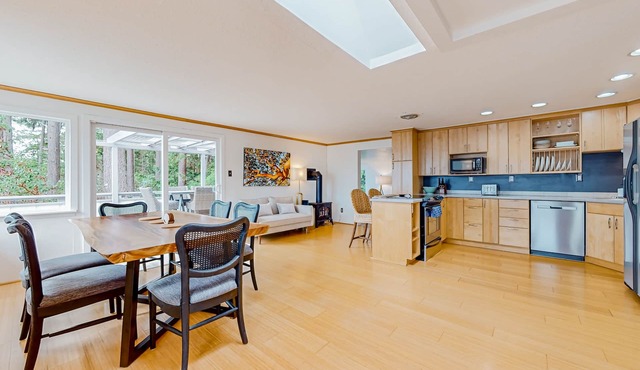 Modern water view retreat with foosball table, expansive deck, and gas fireplace