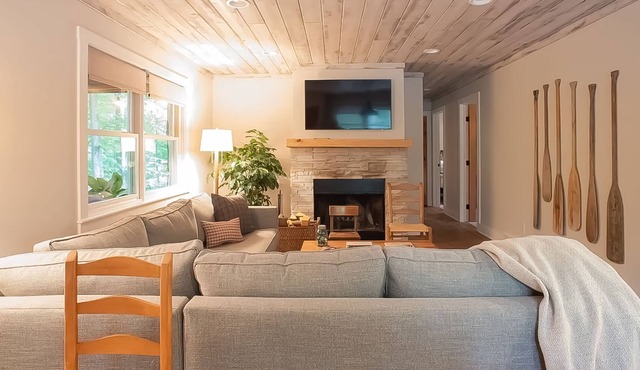 Tree-lined abode with a sprawling deck, large yard, grill, firepit, & central AC